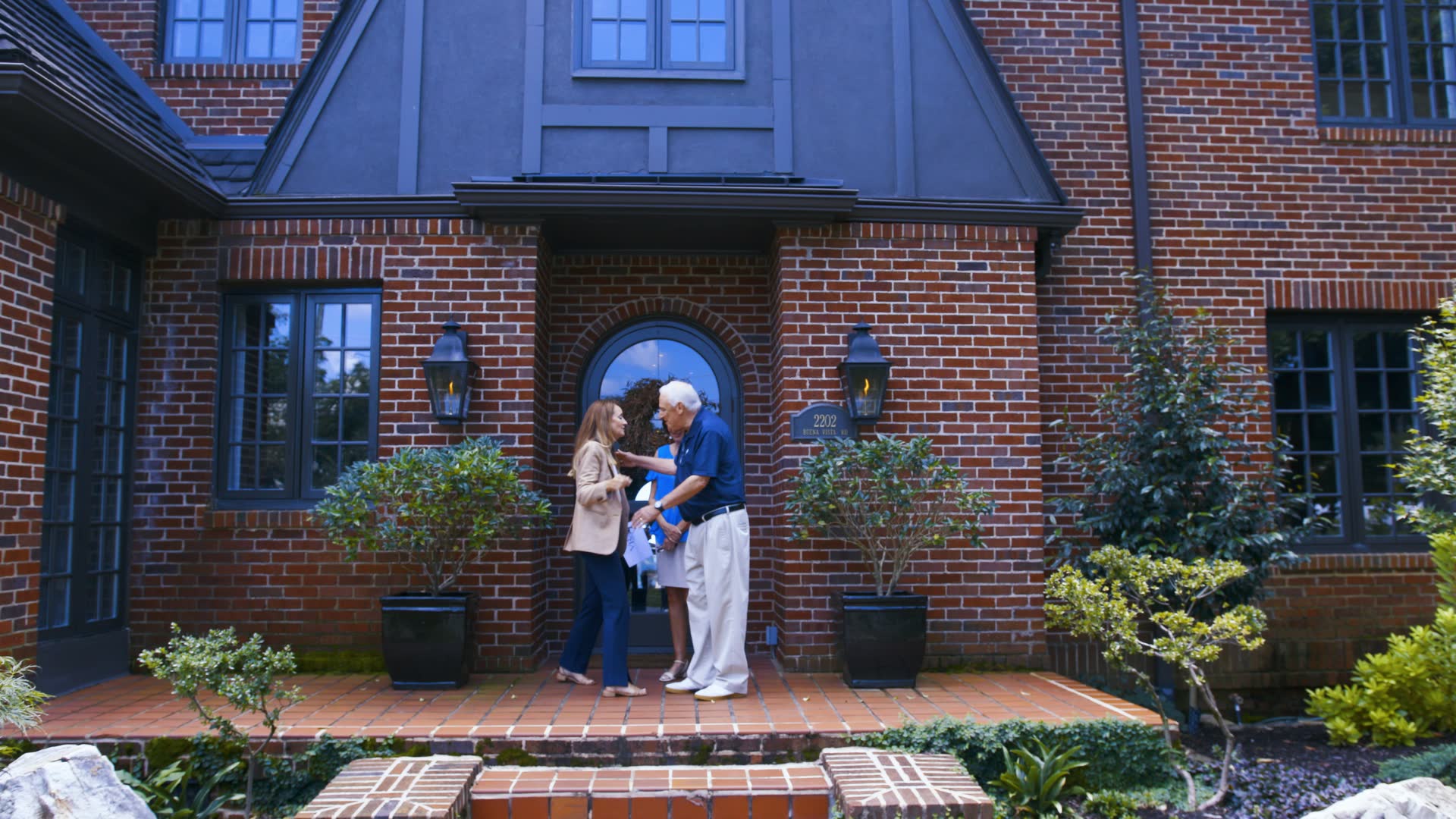 A brick Tudor home with an arched entry